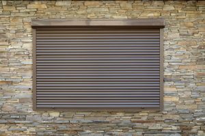 a-window-with-brown-metal-rolling-shutters-wall-decoration-with-artificial-flatten-stone_t20_wlGVj8